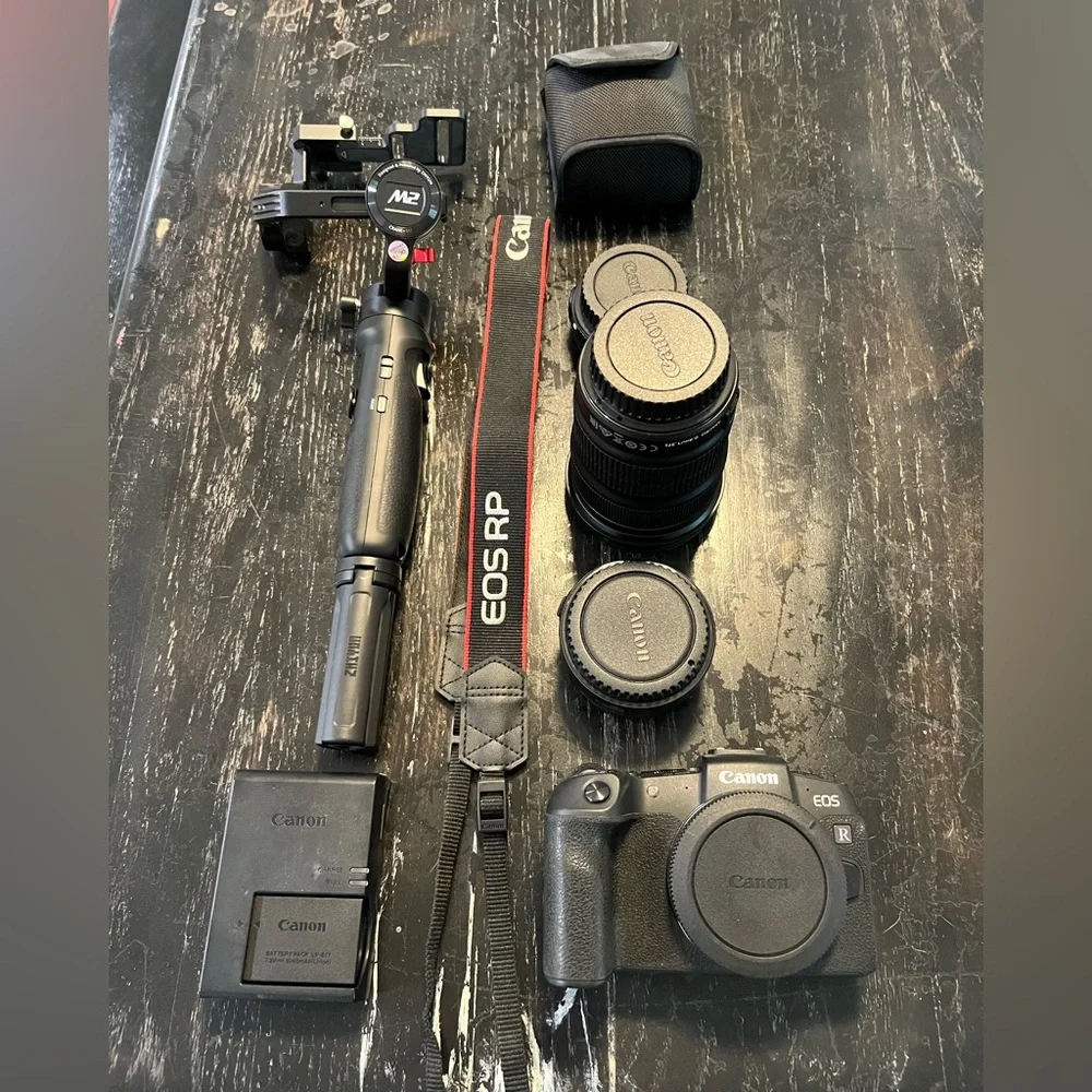 Canon EOS RP with mount adapter, two lenses, gimbal, and strap